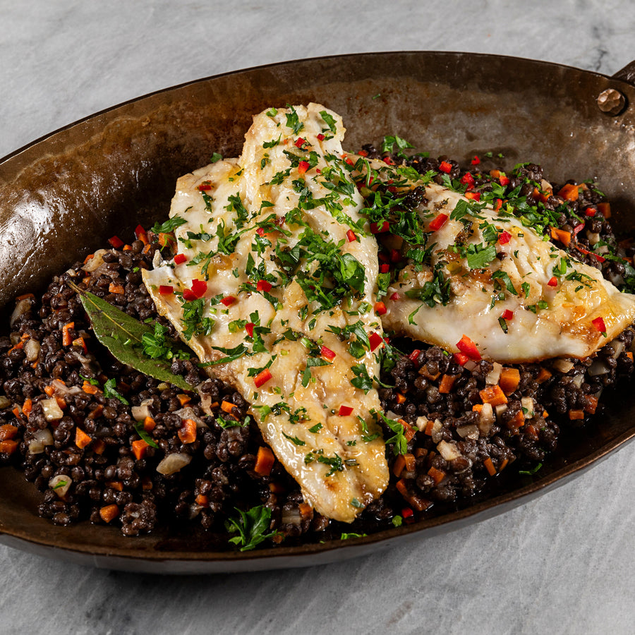 Pan Seared Branzino over Beluga Lentils with Parsley Lime Sauce